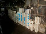many white crates stacked up against a wall in a room