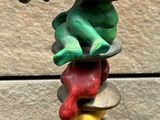 a sculpture of a banana on top of a stack of scissors