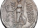 an image of a silver coin with a woman holding a sword