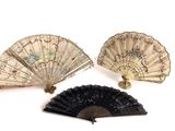three antique fan are sitting next to each other on a white surface