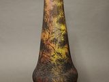 a vase that has a picture of a forest on it