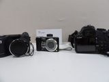 three cameras sitting on a table next to each other