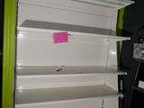 a white shelf that has a pink sticker on it