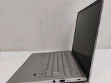 the back of a laptop computer sitting on top of a white table