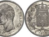 a silver coin with a crown on top of it
