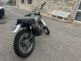 a dirt bike parked in front of a stone building