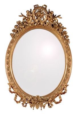 a gold mirror on a white wall with a white background