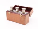 a wooden box with four glasses in it
