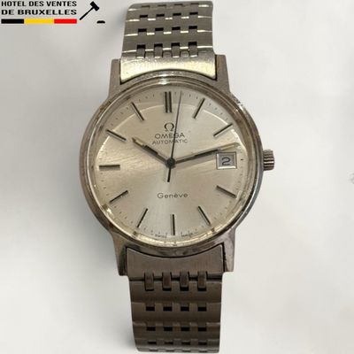 a silver watch that is sitting on a table
