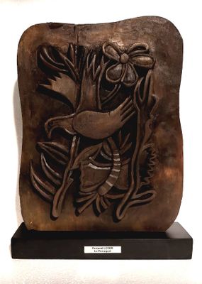 une sculpture représentant un oiseau et une fleur, exposée