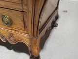 a wooden dresser with a mirror on top of it