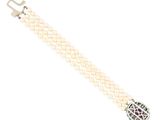 a close up of a white bracelet with pearls and a silver clasp