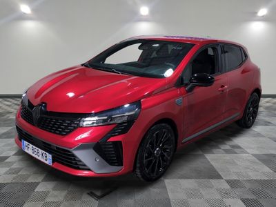 a red car parked on a checkered floor in a garage