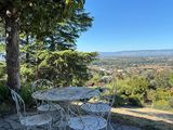 a table and chairs on the patio overlooking the valley