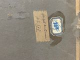 a piece of paper with a sticker on it sitting on a table