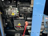 a close up of a blue machine with a red hose on it