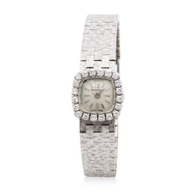 a close up of a watch with diamonds on a white background