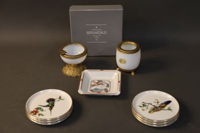 three plates and a bowl on a table with a box