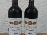 two bottles of wine sitting on a wooden table