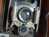 an old camera sitting on top of a wooden box