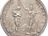 a close up of a silver coin with a man and woman on it