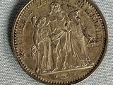 an old coin with an image of a woman and two men on it