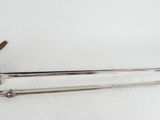 a pair of swords with a wooden handle on a white surface