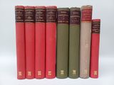 six red and green books lined up in a row on a white surface