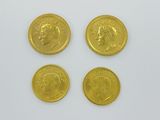 three gold coins with a picture of a man and a woman on them