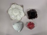 three pieces of glass sitting on a white surface