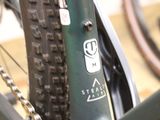 a close up of a bike chain with a sticker on it