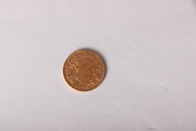a small coin sitting on top of a white surface