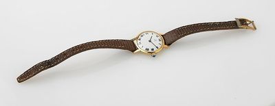 an image of a watch on a white surface with a white background