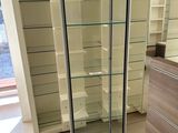 a glass display case in the middle of a room