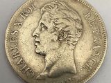 a silver coin with a woman ' s face on it