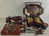 a lot of silver spoons and spoons on a table