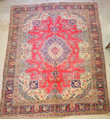 a red and blue rug with a medallion design on it
