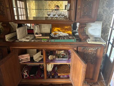 a wooden cabinet with a mirror on top of it
