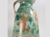 a blue and white vase with a painting of animals on it