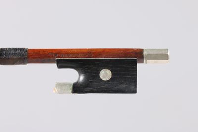 bow of a violin made of wood and metal on a white background