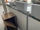 a desk that has a bunch of computers on top of it