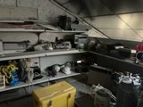 a man standing in a garage with a yellow box