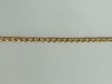 a close up of a gold chain on a white surface