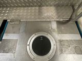 a drain in the floor of a building with signs on it