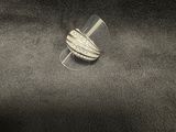 a close up of a silver ring on a black cloth