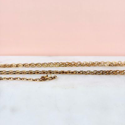 a close up of a gold chain with a heart pendant on it