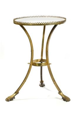a gold metal table with a glass top on a white background