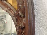 a mirror that is hanging on the wall next to a wall