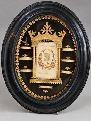 black and gold framed picture of a clock with a crown on it