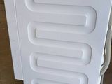 an image of a white refrigerator in a warehouse